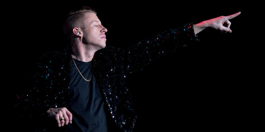 Macklemore points to the crowd during his performance at the Bryce Jordan Center in 2013.