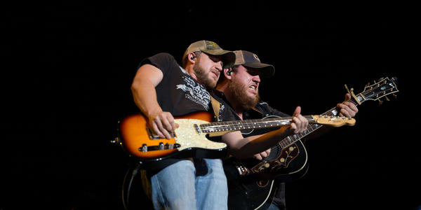 Luke Combs plays guitar during his opening performance for Brantley Gilbert in 2017.
