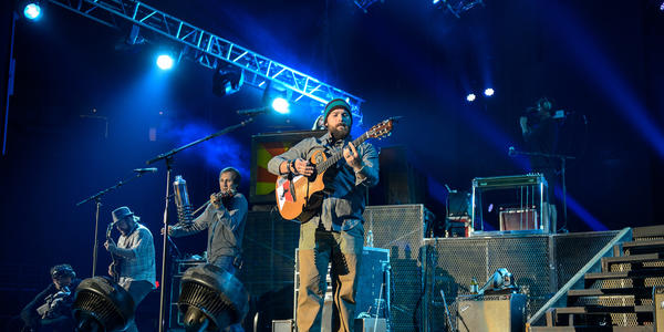 Zac Brown Band performs under blue stage lights while the crowd sings along to the song "Whatever It Is".