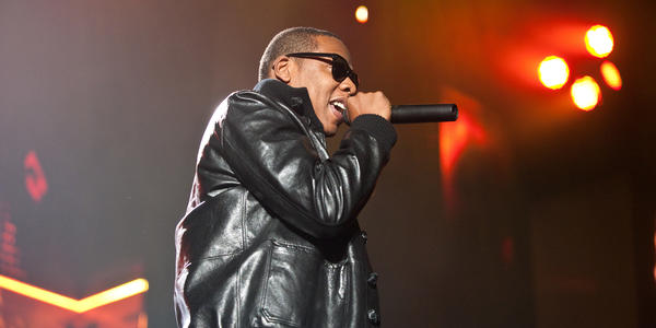 Sporting a black leather jacket and shades, Jay-Z raps into his microphone during his performance at the BJC. 