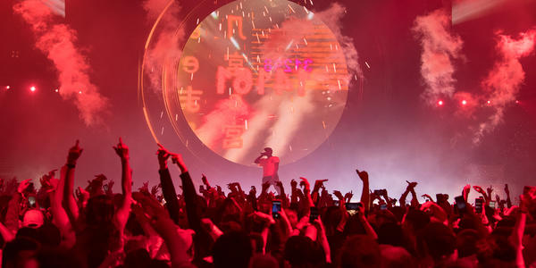 Travis Scott performs on stage for a large crowd at Bryce Jordan Center 