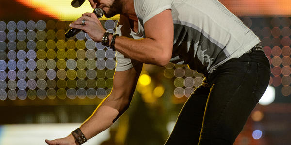 Luke Bryan high fives the crowd in front of the stage during his concert at the Bryce Jordan Center in 2013.