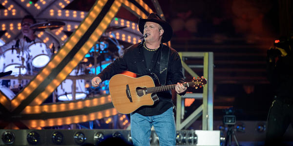 Garth Brooks sings & plays guitar for the audience at the Bryce Jordan Center.