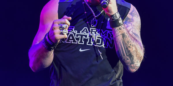 Brantley Gilbert sings into a handheld microphone to the crowd at the BJC.
