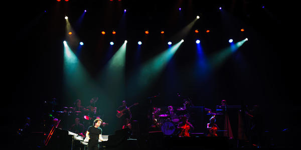 Yanni performs on stage with his musicians at the Bryce Jordan Center in 2011.
