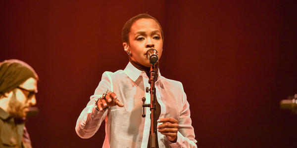 Ms. Lauryn Hill singing into standing microphone during her performance at the BJC in 2014.