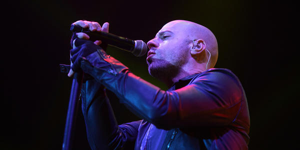 Lead singer of Daughtry sings into standing microphone during their concert at the Bryce Jordan Center in 2012.