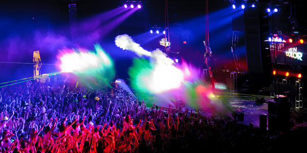 Electric musician, DayGlow, mixes dance beats and paints the crowd using paint cannons on stage at the BJC in 2012.