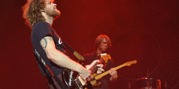 Indie rock band, Dispatch, plays on stage at the Bryce Jordan Center in 2011.