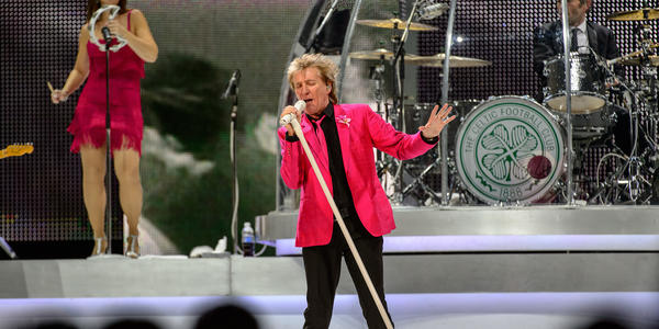 Rod Stewart, tilting his white standing microphone sings on stage during his concert at the BJC in 2013.