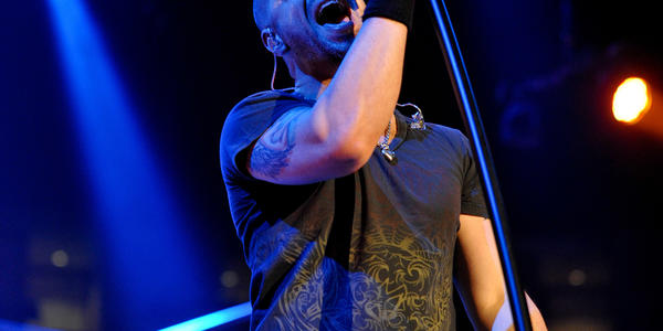 Lead singer of Daughtry sings into standing microphone during their concert at the Bryce Jordan Center in 2010.