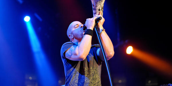 Lead singer of Daughtry sings into standing microphone during their concert at the Bryce Jordan Center in 2010.