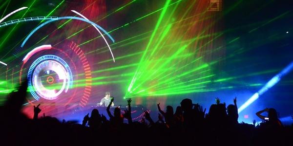 Hardwell, DJ, mixes beats on stage under a rainbow of laser and strobe lights for the dancing BJC crowd