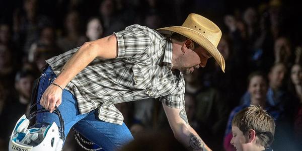 Jason Aldean leans down from stage to greet young audience members at the BJC in 2016