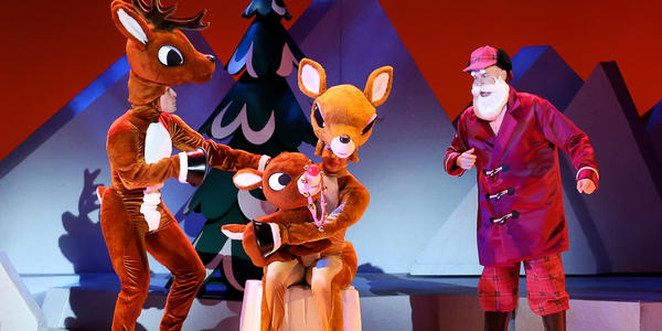 Rudolph the Red Nosed Reindeer with parents and Santa on stage at the Bryce Jordan Center.