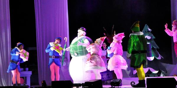 Sam the Snowman, sings on stage with Santa's elves for the audience at the Bryce Jordan Center. 